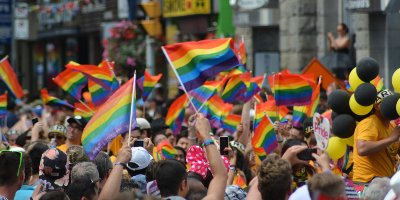 Crowd waving rainbow flags