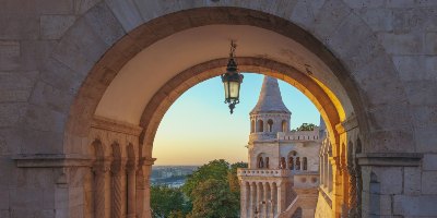 View through stone archway towards ancient town - Historical Linguistics<