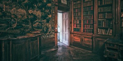 View of wooden-panelled library room with wall tapestry and open door letting in light - Poetry, Rhetoric and Poetics