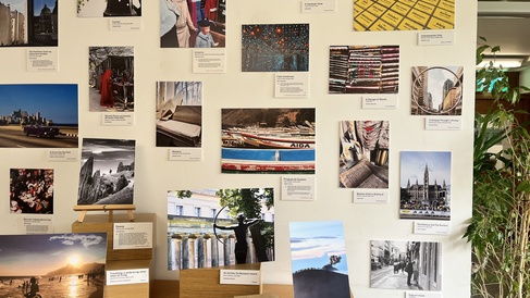 A wall of photographs and captions in the MMLL Library foyer.