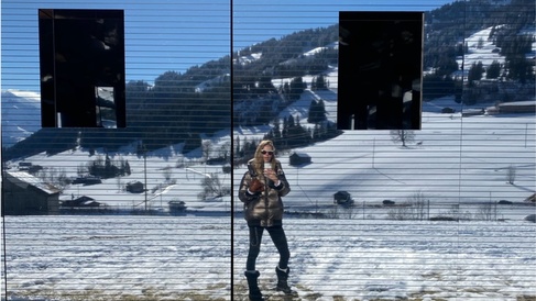 Woman's reflection in snowy landscape