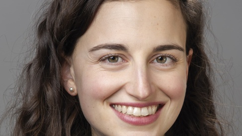 smiling woman with curly brown hair