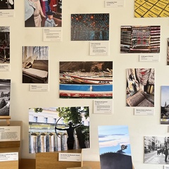 A wall of photographs and captions in the MMLL Library foyer.