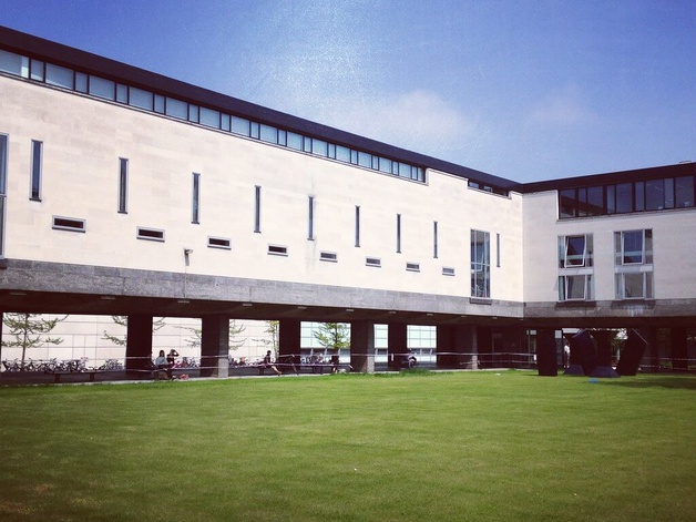 The Raised Faculty Building and the lawn beside it on a sunny day