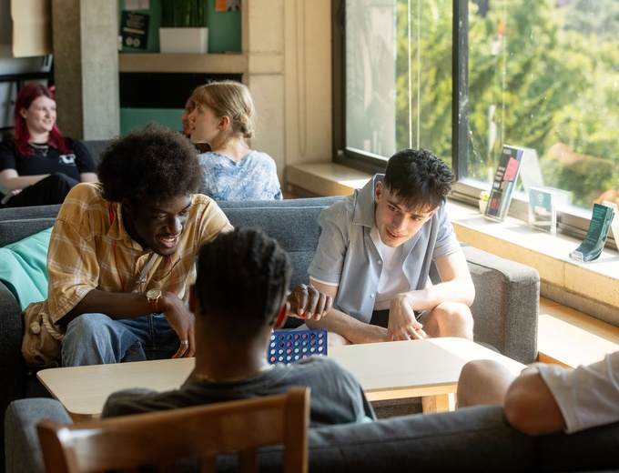 seated students chatting indoors