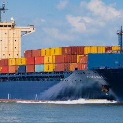 Blue container ship laden with brightly-coloured boxes. Image by dendoktoor from Pixabay 