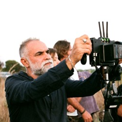 Karim Aïnouz holding a camera.