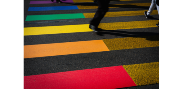 Street with rainbow coloured striped crosswalk
