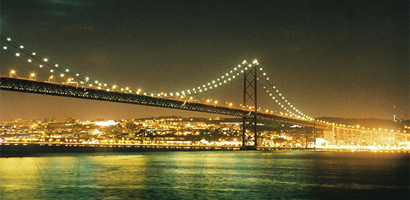 Bridge over the River Tagus at night, illuminated